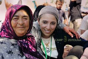 Lina Sergie Attar with a woman from rural Idlib, Atmeh camp, Syria. photo by Mohamed Ojjeh